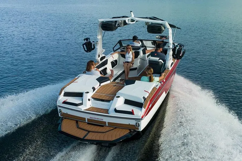 Slide: The Image of Manufacturer Provided Image: 2024 Nautique Super Air Nautique GS22 boat cruising with passengers on a lake. - 22