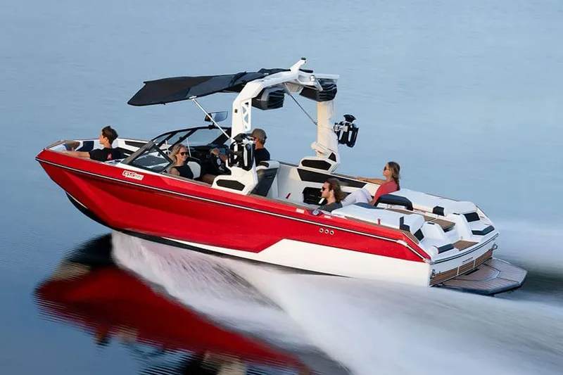 Slide: The Image of Manufacturer Provided Image: 2024 Nautique Super Air Nautique GS22 in red, cruising on calm water. - 23
