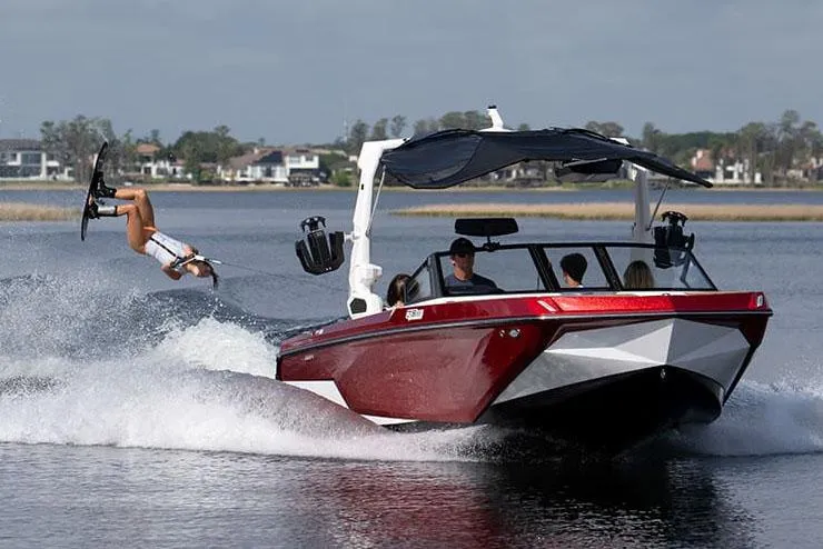 Slide: The Image of Manufacturer Provided Image: 2024 Nautique Super Air Nautique GS22 towing a wakeboarder on a lake. - 26