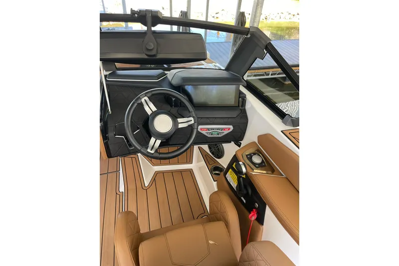 Slide: The Image of 2024 Nautique Super Air Nautique GS22 cockpit with modern steering and controls. - 8