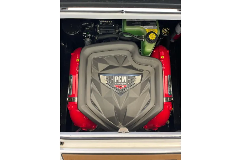 Slide: The Image of 2024 Nautique Super Air Nautique GS22 engine with PCM cover and red components. - 9