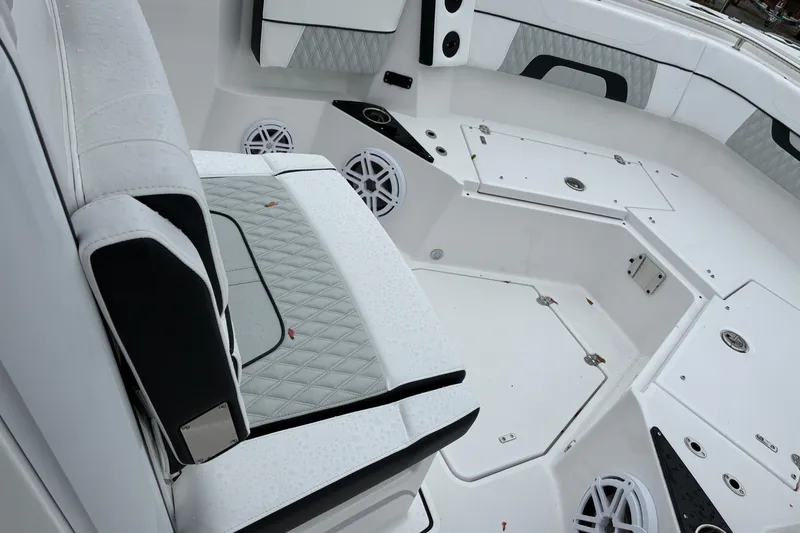 Slide: The Image of 2026 Blackfin 272 CC boat interior with white seating and storage compartments. - 17
