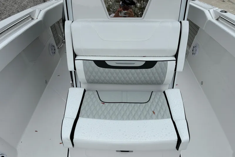 Slide: The Image of 2026 Blackfin 272 CC boat interior with white cushioned seating and diamond stitching. - 19