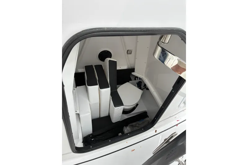 Slide: The Image of 2026 Blackfin 272 CC boat interior with compact toilet and seating. - 23