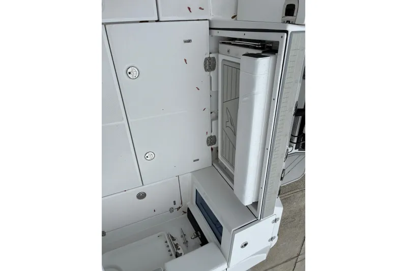 Slide: The Image of 2026 Blackfin 272 CC boat interior storage compartment with foldable seat and utility features. - 24