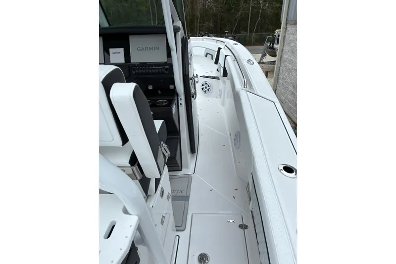 Slide: The Image of 2026 Blackfin 272 CC boat interior with Garmin navigation system, sleek white design. - 29