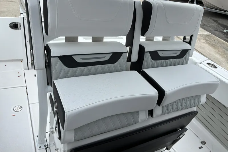 Slide: The Image of Luxury seating on 2026 Blackfin 272 CC boat, featuring sleek white and black upholstery. - 33
