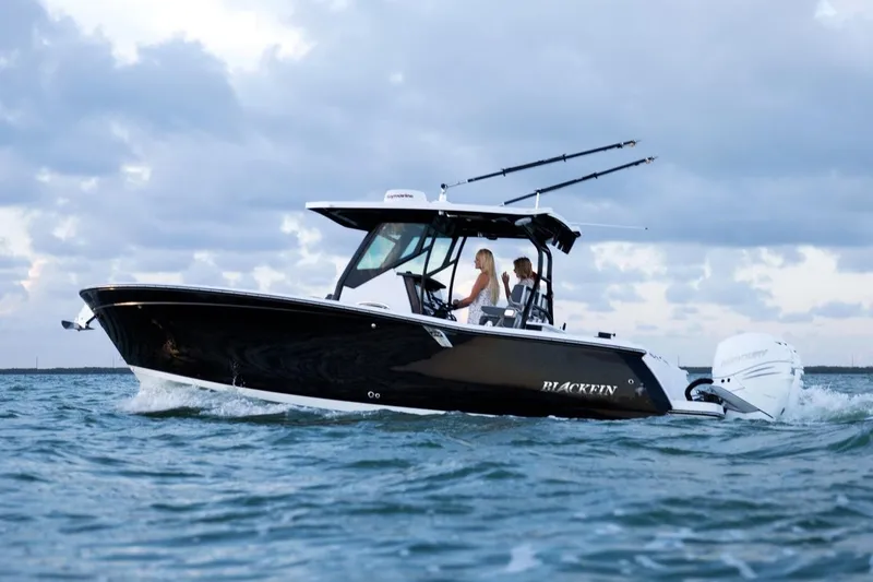 Slide: The Image of Manufacturer Provided Image: 2026 Blackfin 272 CC boat cruising on open water under cloudy sky. - 7