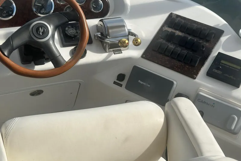 Slide: The Image of Helm of 2001 Sea Ray 400 Sedan Bridge with steering wheel and navigation controls. - 14