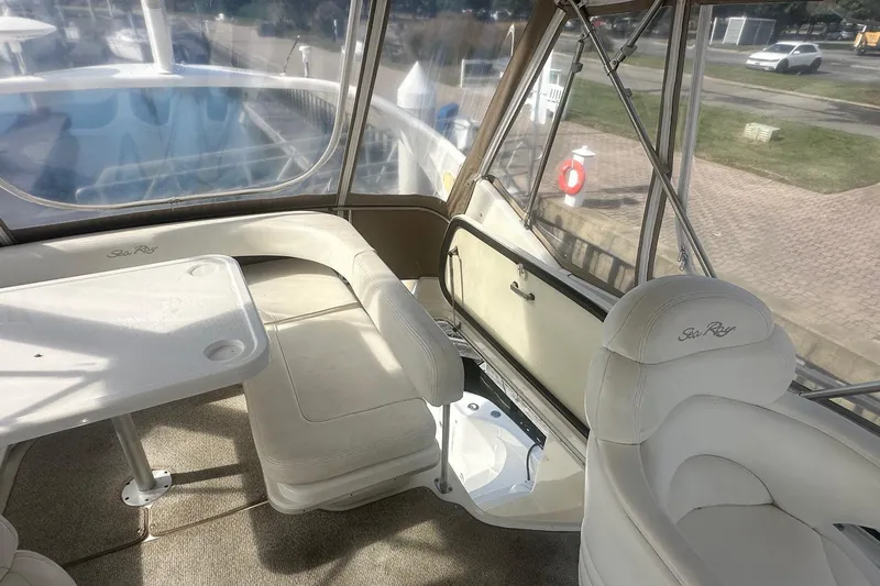 Slide: The Image of Interior of 2001 Sea Ray 400 Sedan Bridge with white seating and table. - 17