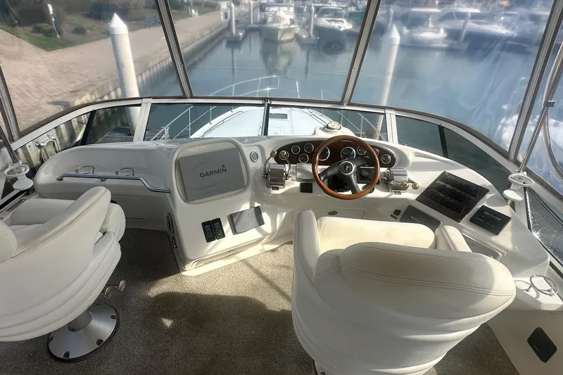 Slide: The Image of Cockpit of 2001 Sea Ray 400 Sedan Bridge with Garmin navigation system and luxurious seating. - 18