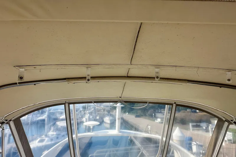 Slide: The Image of Interior view of 2001 Sea Ray 400 Sedan Bridge boat canopy and windows. - 19
