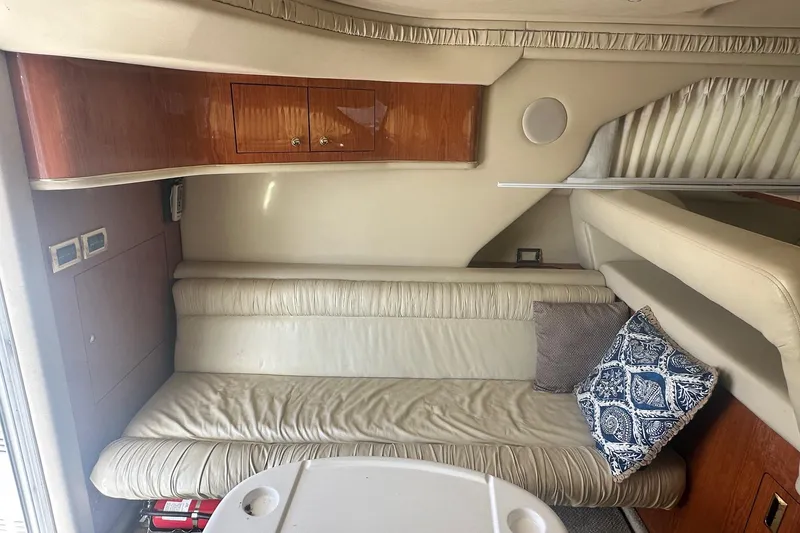 Slide: The Image of Interior of 2001 Sea Ray 400 Sedan Bridge with beige seating and decorative pillows. - 21