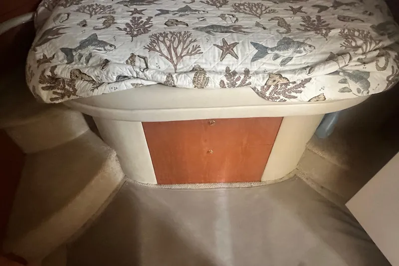 Slide: The Image of Interior cabin of 2001 Sea Ray 400 Sedan Bridge with marine-themed bedding. - 24