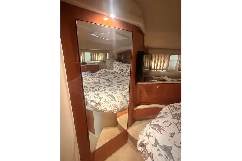 Slide: The Image of Interior of 2001 Sea Ray 400 Sedan Bridge with mirrored closet and cozy bedding. - 27