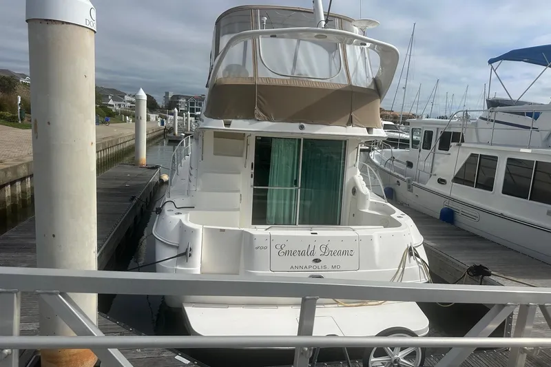 Slide: The Image of 2001 Sea Ray 400 Sedan Bridge yacht docked, named "Emerald Dreamz," in Annapolis marina. - 3