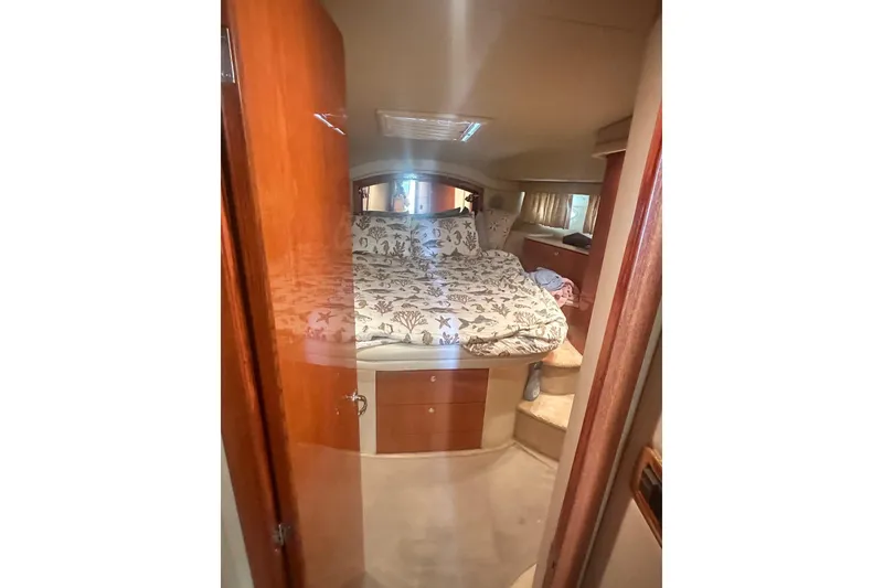 Slide: The Image of Interior cabin of 2001 Sea Ray 400 Sedan Bridge with cozy bed and wooden accents. - 30