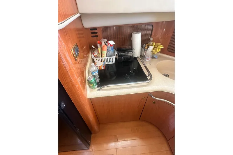 Slide: The Image of 2001 Sea Ray 400 Sedan Bridge kitchen with stove, sink, and storage. - 31