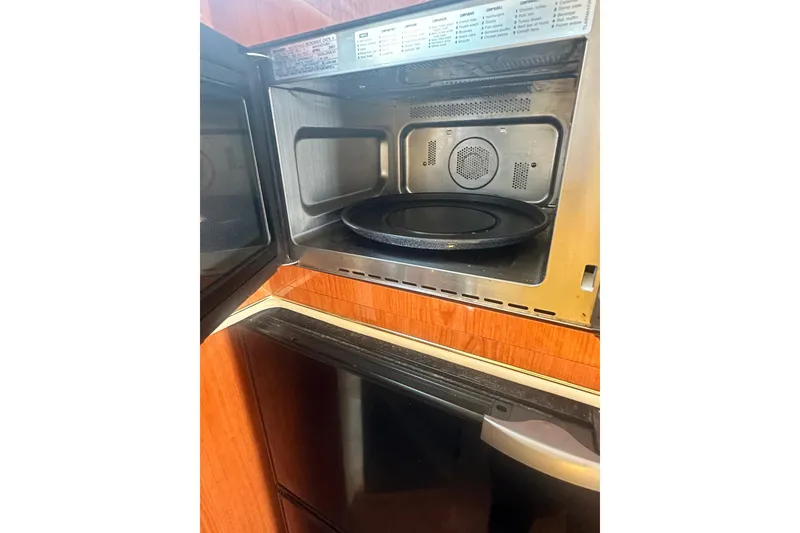 Slide: The Image of Open microwave inside a 2001 Sea Ray 400 Sedan Bridge yacht kitchen. - 32
