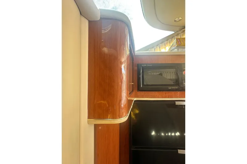 Slide: The Image of Interior of 2001 Sea Ray 400 Sedan Bridge with wood cabinetry and built-in microwave. - 35