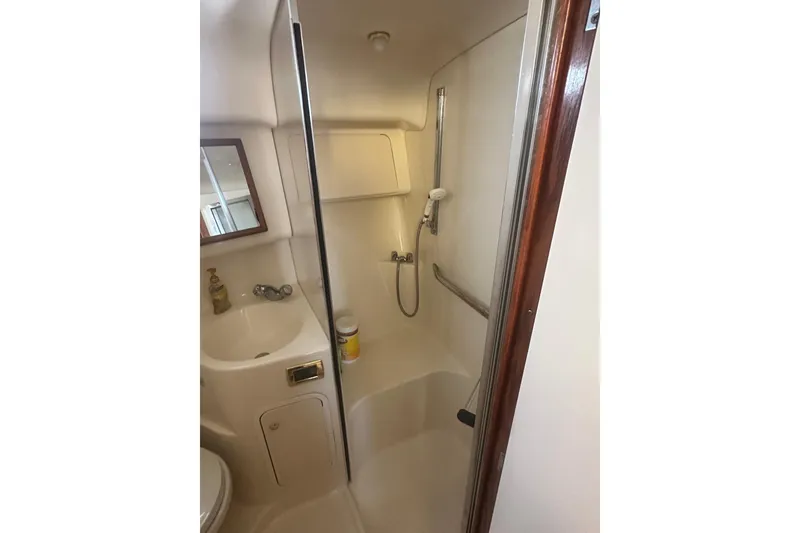 Slide: The Image of 2001 Sea Ray 400 Sedan Bridge bathroom with shower and sink. - 36