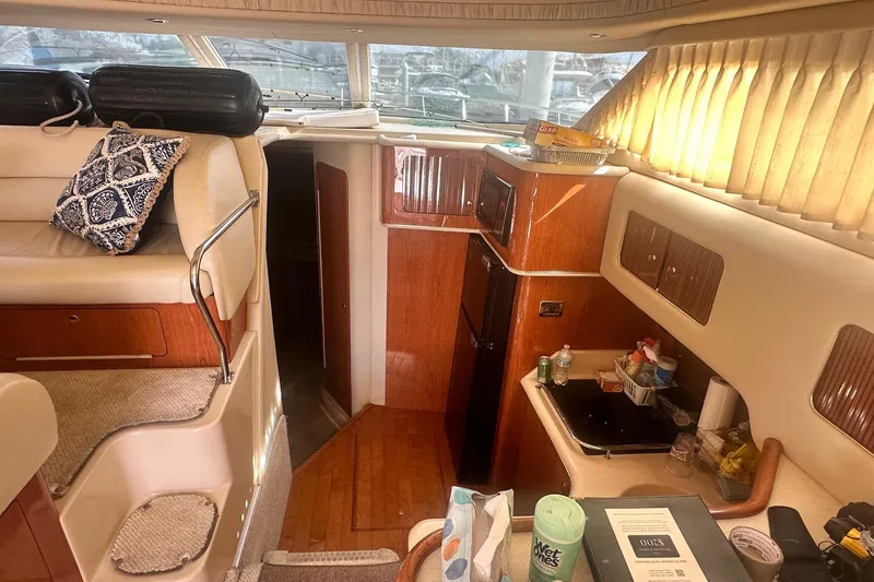 Slide: The Image of Interior of 2001 Sea Ray 400 Sedan Bridge yacht with cozy seating and kitchenette. - 41