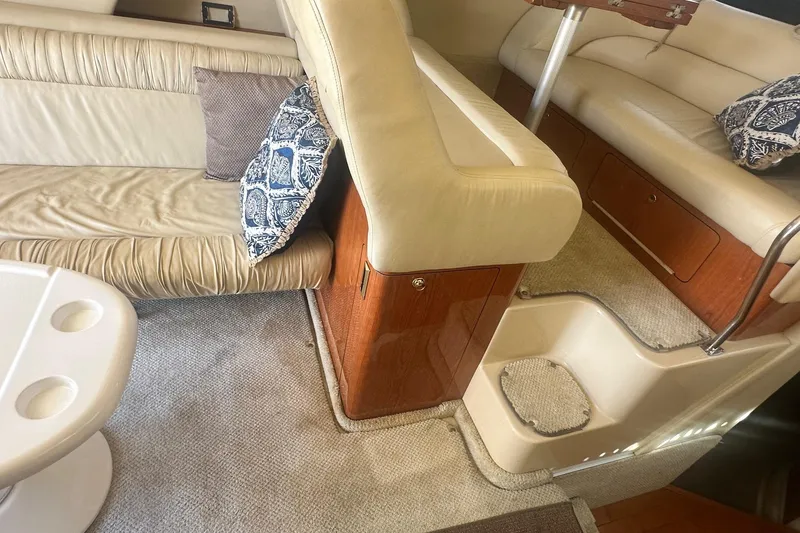 Slide: The Image of Interior of 2001 Sea Ray 400 Sedan Bridge with beige seating and decorative pillows. - 43