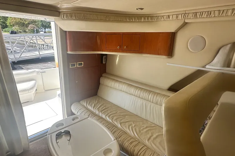 Slide: The Image of Interior of 2001 Sea Ray 400 Sedan Bridge with beige seating and wooden cabinets. - 44