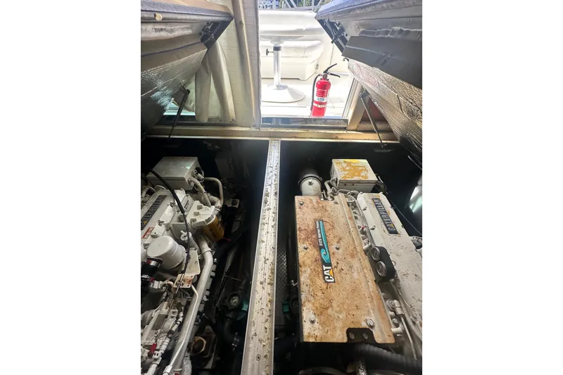 Slide: The Image of Engine compartment of a 2001 Sea Ray 400 Sedan Bridge with visible machinery and fire extinguisher. - 46