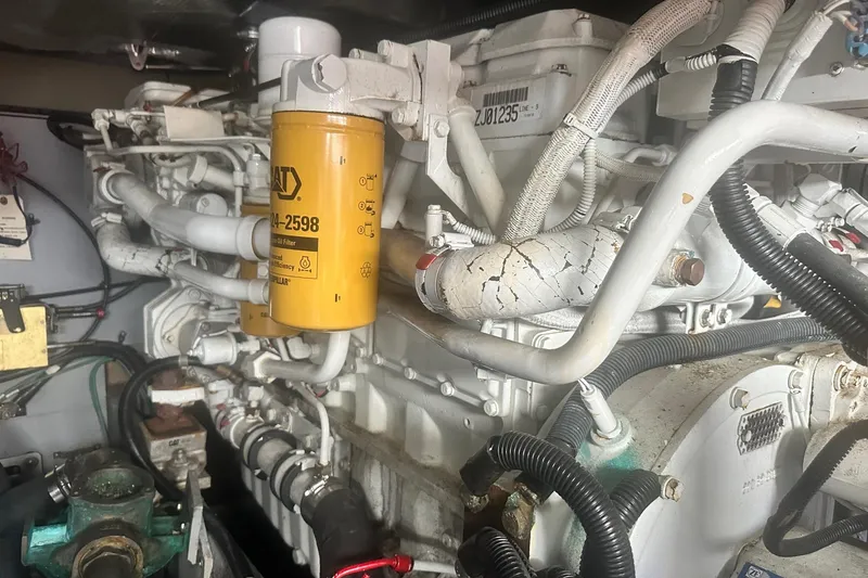 Slide: The Image of Engine compartment of a 2001 Sea Ray 400 Sedan Bridge with visible CAT oil filter. - 51