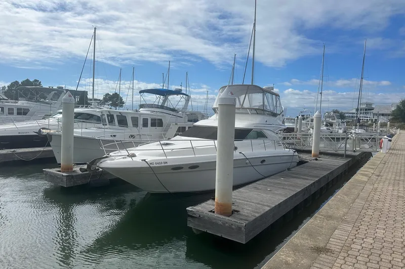 Slide: The Image of 2001 Sea Ray 400 Sedan Bridge yacht docked at marina under blue sky. - 6