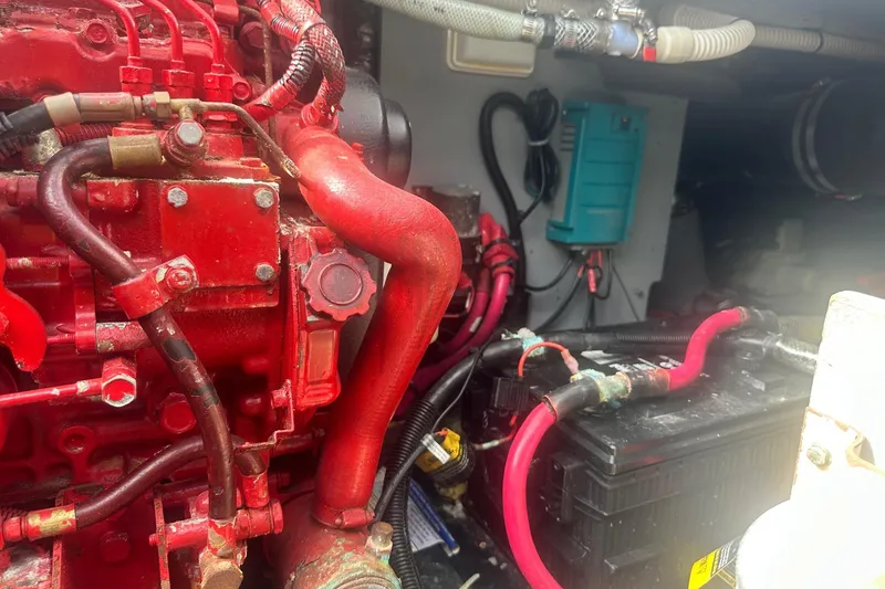 Slide: The Image of Engine compartment of a 2001 Sea Ray 400 Sedan Bridge with red components and wiring. - 64