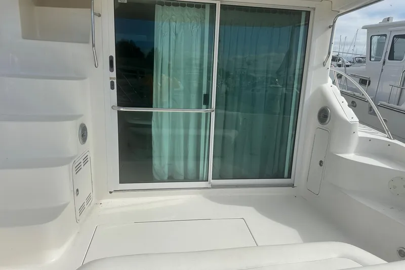 Slide: The Image of 2001 Sea Ray 400 Sedan Bridge yacht with sliding glass door and white deck. - 8