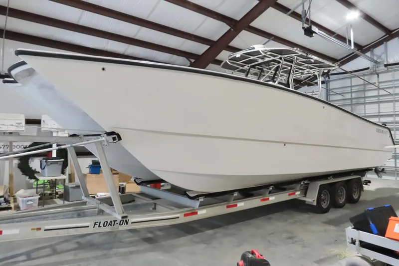 Slide: The Image of 2013 Freeman 33 boat on trailer in a storage facility. - 13