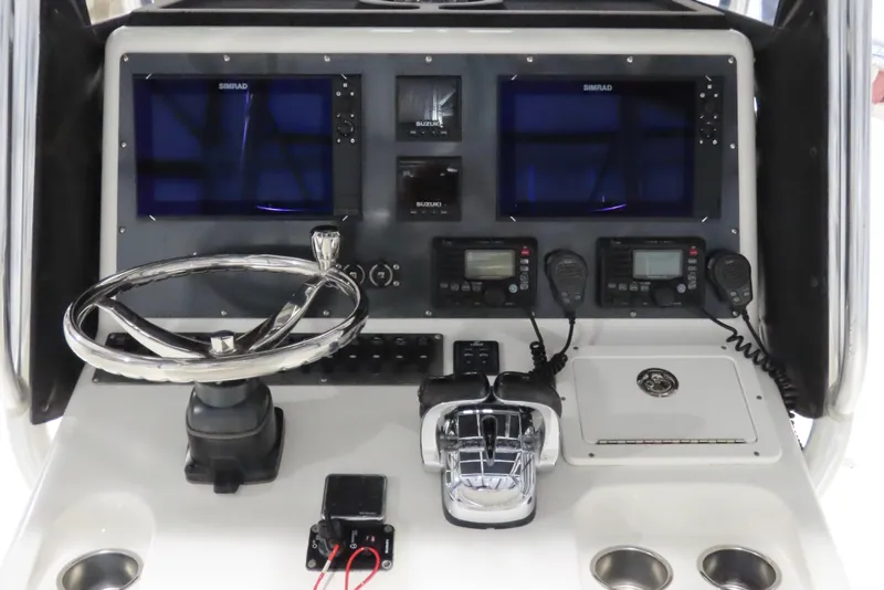 Slide: The Image of Control panel of a 2013 Freeman 33 boat with dual screens and steering wheel. - 16