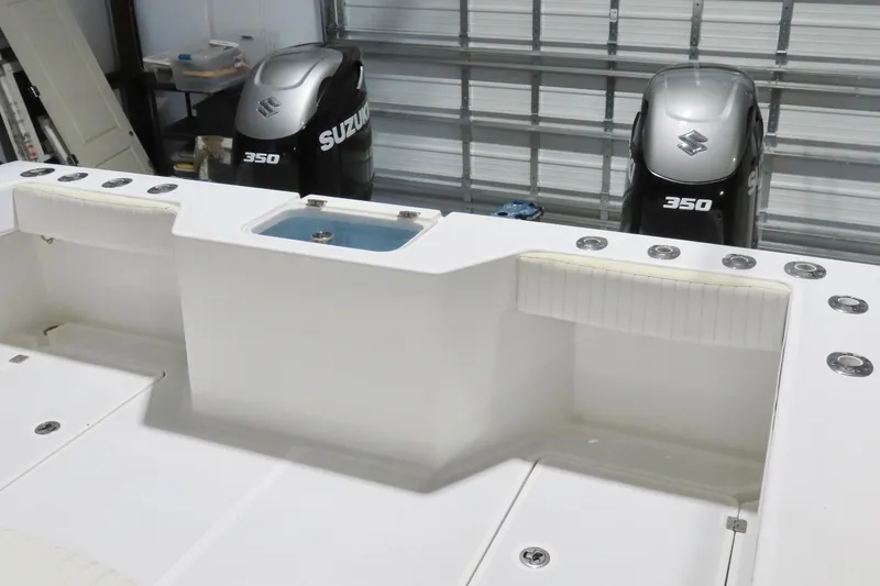 Slide: The Image of Freeman 33 boat with dual Suzuki 350 engines, 2013 model, in a garage setting. - 19