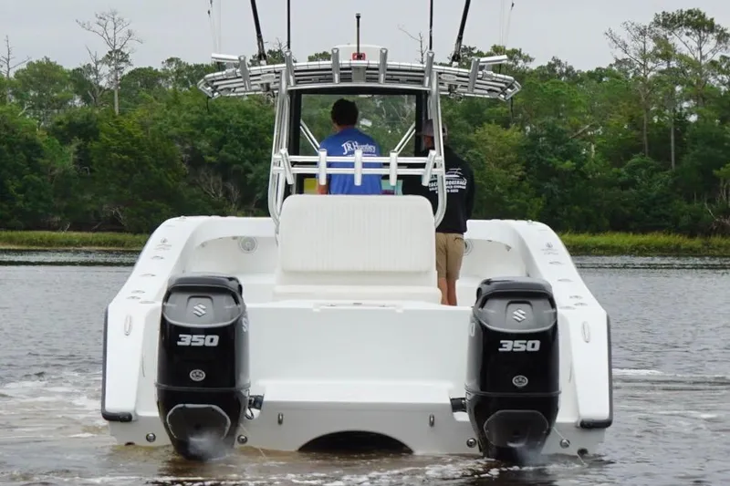 Slide: The Image of Freeman 33 boat with dual Suzuki 350 engines on a calm waterway, 2013 model. - 3