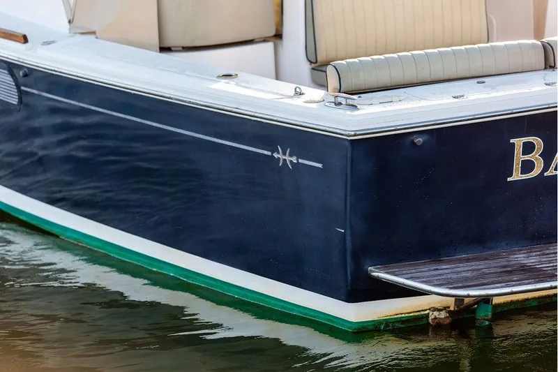 Slide: The Image of 2007 Hunt Surfhunter 29 boat, blue hull, docked on water. - 16