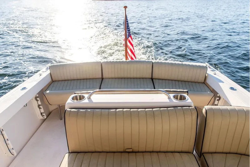 Slide: The Image of 2007 Hunt Surfhunter 29 boat interior with seating, American flag, and ocean view. - 19