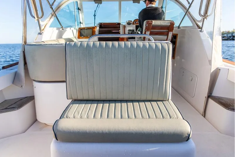 Slide: The Image of 2007 Hunt Surfhunter 29 boat interior with cushioned seating and steering area. - 20