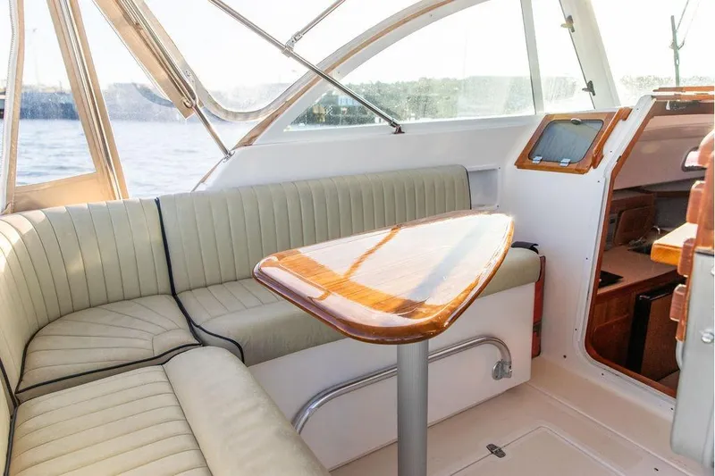 Slide: The Image of Interior of 2007 Hunt Surfhunter 29 boat with seating and wooden table. - 25