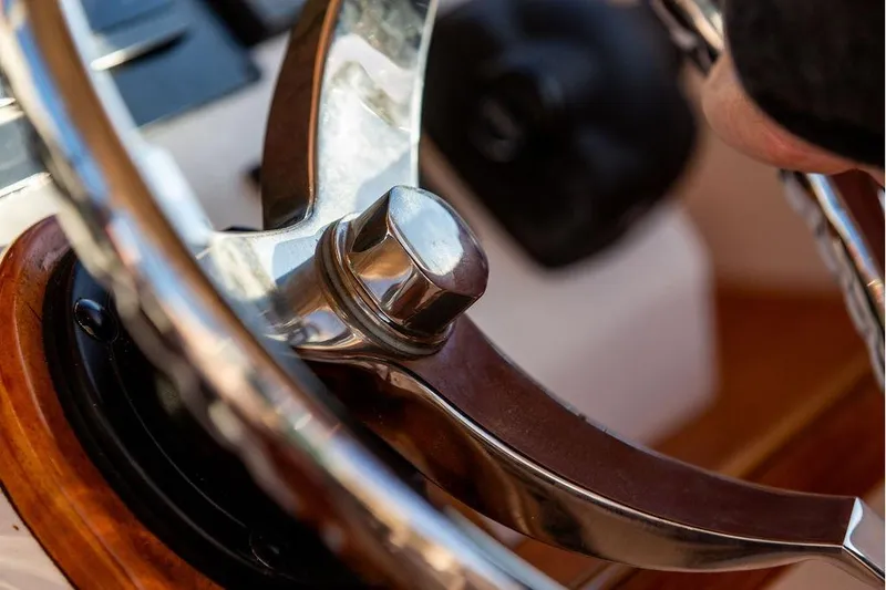 Slide: The Image of Close-up of 2007 Hunt Surfhunter 29 steering wheel, showcasing polished metal and wood details. - 33
