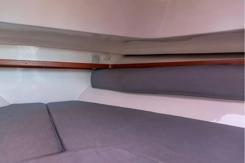Slide: The Image of Interior cabin of 2007 Hunt Surfhunter 29 with gray cushions and wooden trim. - 41