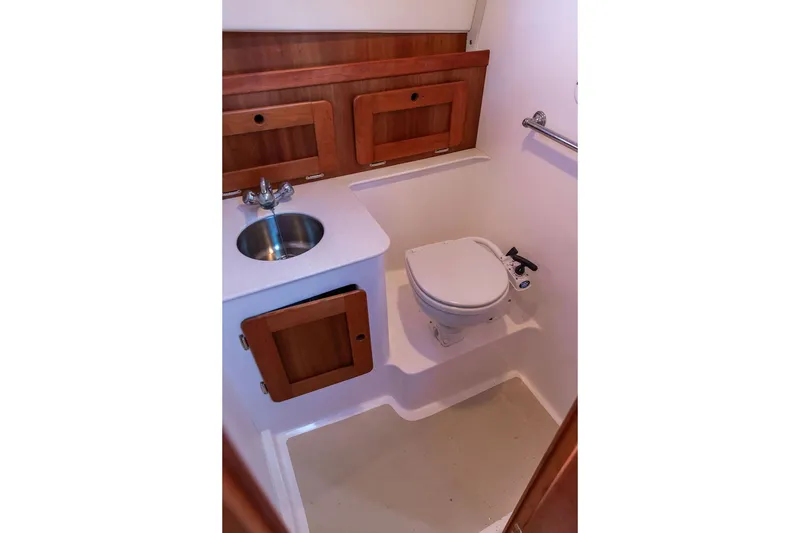 Slide: The Image of Compact bathroom in 2007 Hunt Surfhunter 29 with sink, toilet, and wooden cabinetry. - 44