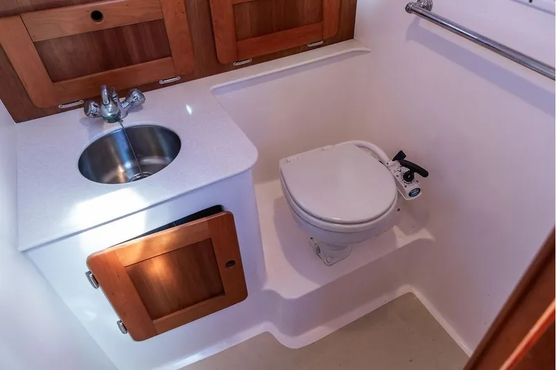 Slide: The Image of Compact bathroom in 2007 Hunt Surfhunter 29 boat with sink and marine toilet. - 45