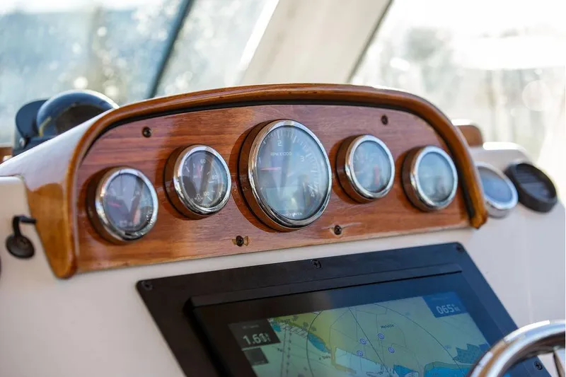 Slide: The Image of Dashboard of 2007 Hunt Surfhunter 29 boat with gauges and navigation screen. - 29