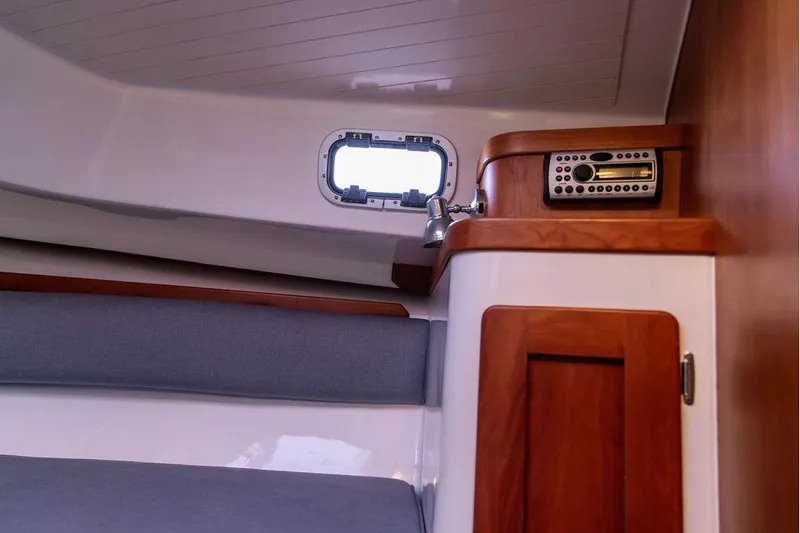 Slide: The Image of Interior of 2007 Hunt Surfhunter 29 boat with wood accents and porthole window. - 40