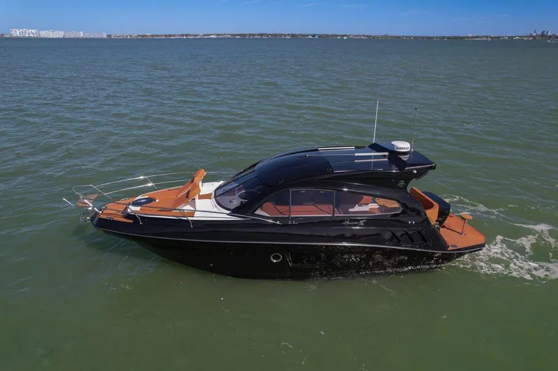 The Image of 2025 Hanover 355 Outboard boat cruising on open water, sleek black design. - 0
