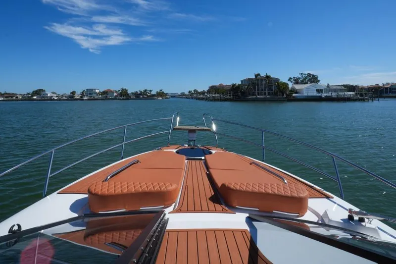 Slide: The Image of 2025 Hanover 355 Outboard boat cruising on a sunny day, with waterfront view. - 4