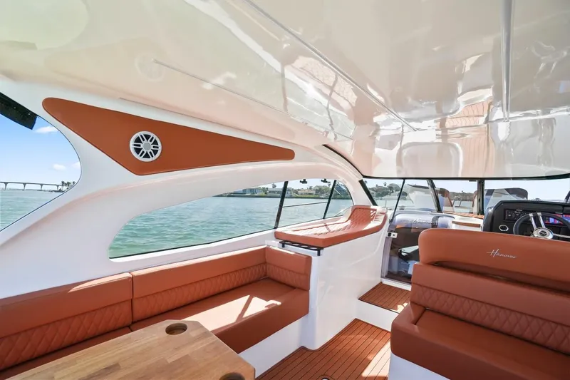 Slide: The Image of Luxurious interior of 2025 Hanover 355 Outboard boat with leather seating and wood accents. - 8